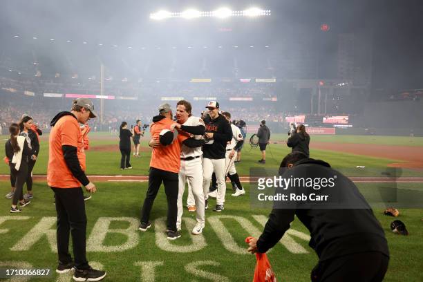 Adley Rutschman of the Baltimore Orioles celebrates after the Orioles defeated the Boston Red Sox to win the American League East at Oriole Park at...