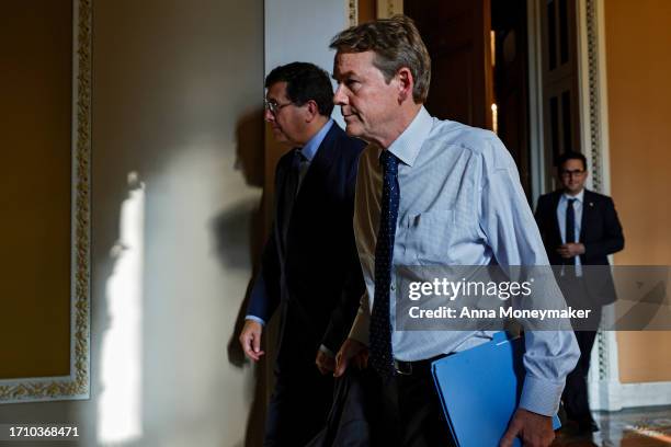 Sen. Michael Bennet leaves a meeting with Senate Democrats at the U.S. Capitol Building following passage in the House of a 45-day continuing...