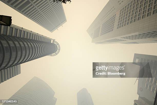 Office buildings stand shrouded in smog in Singapore, on Friday, June 21, 2013. Singapore's smog hit its worst level, blanketing the city-state in...