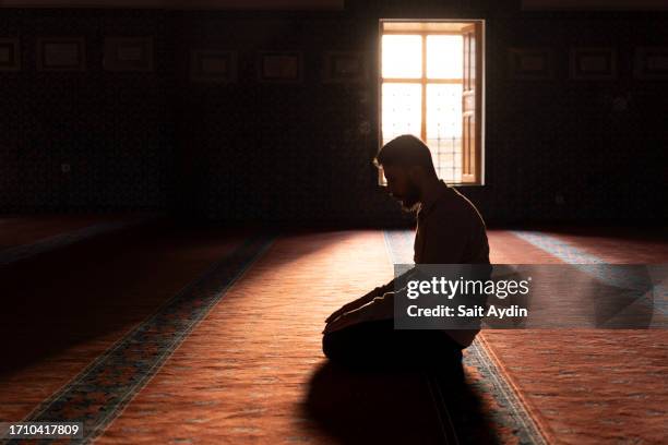 muslim man worshipping in a mosque. - holy book stock pictures, royalty-free photos & images