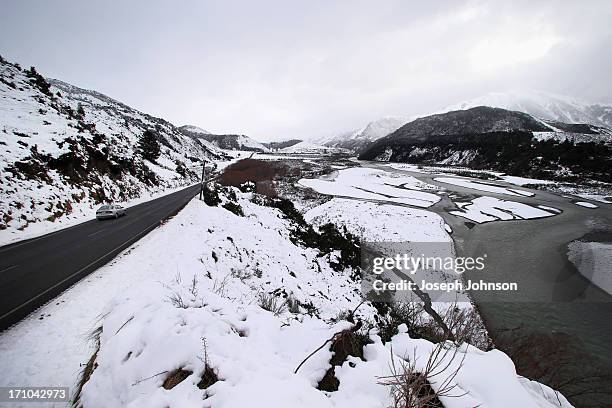 Waiau River bed covered in snow with the Lewis Pass Road in the Lewis Pass on June 21, 2013 in Christchurch, New Zealand. Now, sleet, rain and heavy...