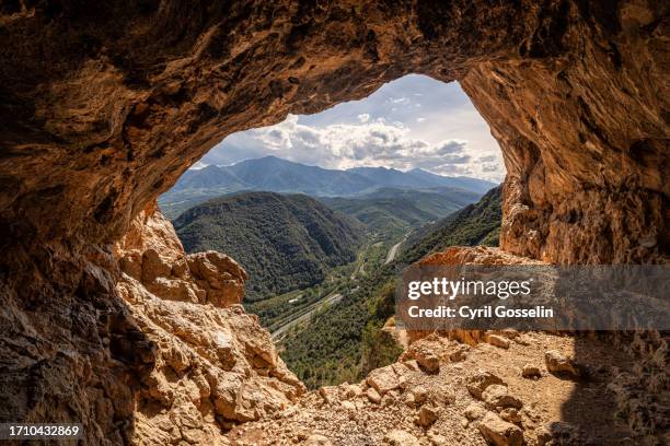 view out of a cavern on the pyrenees mountains - villefranche de conflent photos et images de collection