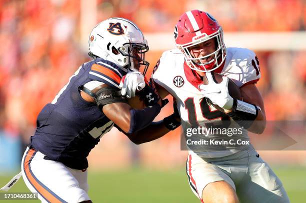 Brock Bowers of the Georgia Bulldogs is tackled by Zion Puckett of the Auburn Tigers during the third quarter at Jordan-Hare Stadium on September 30,...