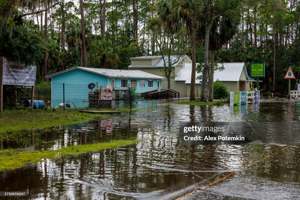 Small community in distress after hurricane landfall. Houses and road drown in water after storm