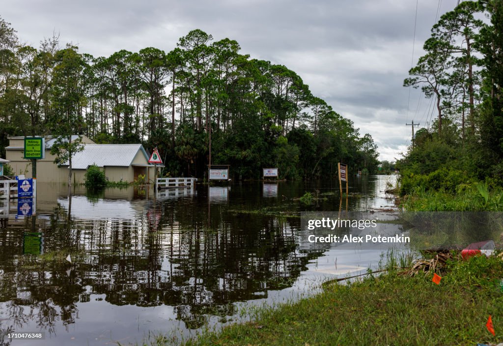 Hurricane landfall in Steinhatchee, North Florida: Residential street and road flooded, houses and trees underwater