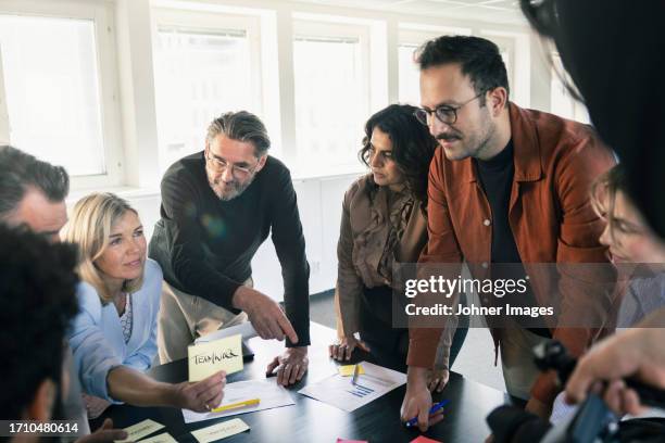 group of business people during meeting in office - office politics stock pictures, royalty-free photos & images