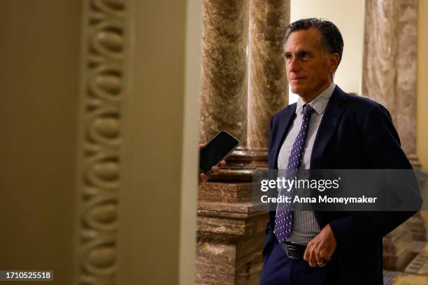 Sen. Mitt Romney speaks to a reporter during a vote on a continuing resolution to fund the government on September 30, 2023 in Washington, DC. The...