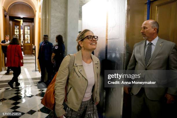 Sen. Kyrsten Sinema departs from the Senate Chambers after a vote on a continuing resolution to fund the government on September 30, 2023 in...