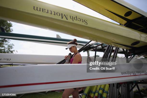 Competitors carry oars at the end of the first day of the Henley Women's Regatta on June 21, 2013 in Henley-on-Thames, England. The annual 3-day...