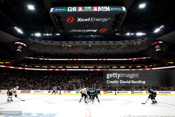 The Chicago Blackhawks and Minnesota Wild prepare for the faceoff at the start of overtime at Xcel Energy Center on September 30, 2023 in St Paul,...