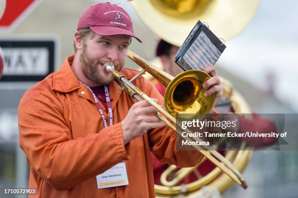 Sean Nettleton plays a song on the trombone during the tailgating events before a college football game between the Montana Grizzlies and Idaho State...