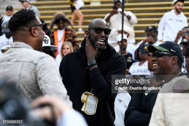 Former NBA player Kevin Garnett stands on the field with former NBA player Paul Pierce and others before a game between the Colorado Buffaloes and...