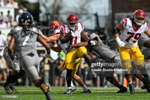 Running back MarShawn Lloyd of the USC Trojans carries the ball against the Colorado Buffaloes in the second quarter at Folsom Field on September 30,...