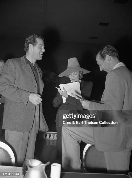 Movie stars Fred MacMurray and Marlene Dietrich rehearse the radio play 'Desire' a charity radio series for the Screen Guild's Motion Picture Relief...