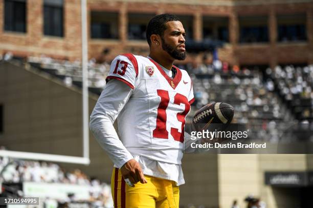Quarterback Caleb Williams of the USC Trojans warms up before a third quarter posession against the Colorado Buffaloes at Folsom Field on September...