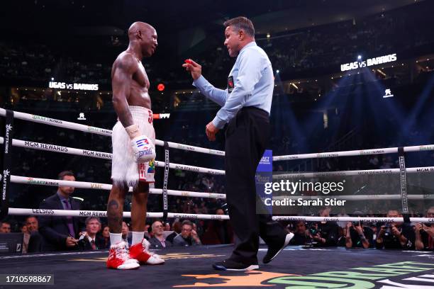 Referee Thomas Taylor talks with Yordenis Ugas about his closed right eye during a middleweight fight with Mario Barrios at T-Mobile Arena on...