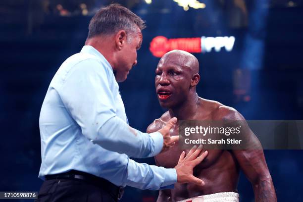 Referee Thomas Taylor talks with Yordenis Ugas about his closed right eye during a middleweight fight with Mario Barrios at T-Mobile Arena on...