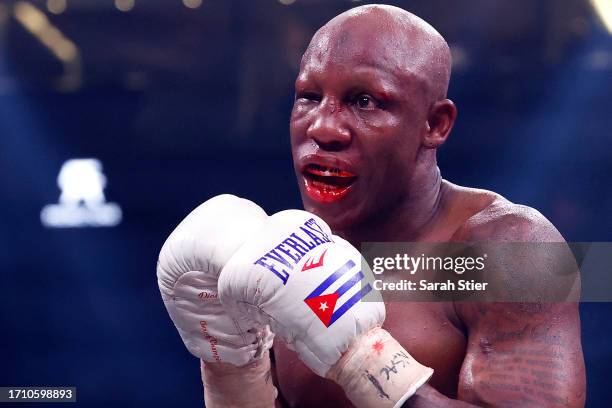 Referee Thomas Taylor talks with Yordenis Ugas about his closed right eye during a middleweight fight with Mario Barrios at T-Mobile Arena on...