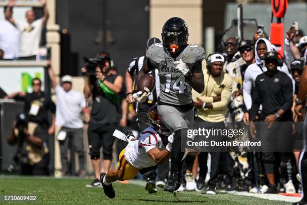 Wide receiver Omarion Miller of the Colorado Buffaloes is tackled by cornerback Domani Jackson of the USC Trojans after a catch in the fourth quarter...