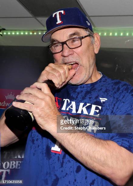 Manager Bruce Bochy of the Texas Rangers celebrates in the clubhouse after the Texas Rangers clinched a 2023 MLB playoff berth Mariners at T-Mobile...