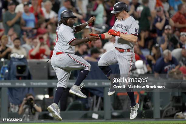 Max Kepler of the Minnesota Twins celebrates with Tommy Watkins as he circles the bases after hitting a 3 RBI home run against the Colorado Rockies...