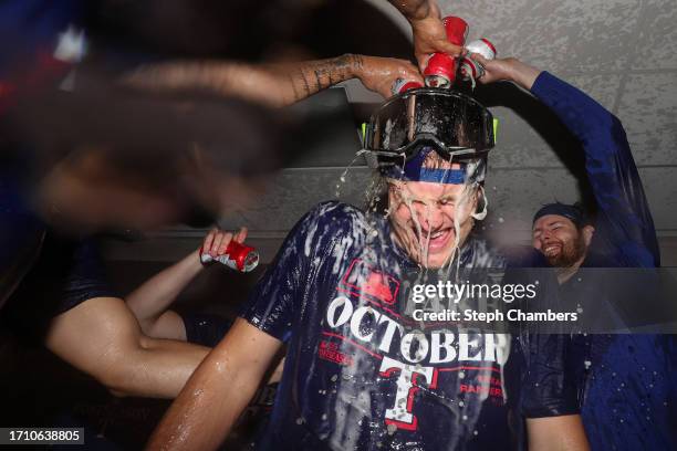 Josh Jung of the Texas Rangers celebrates in the clubhouse after the Texas Rangers clinched a 2023 MLB playoff berth against the Seattle Mariners at...