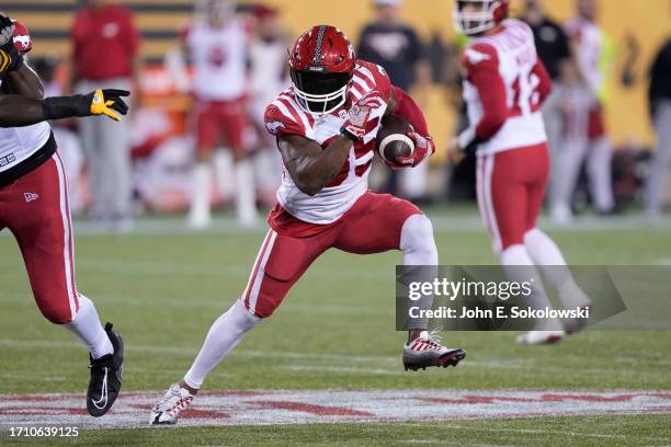 Ka'Deem Carey of the Calgary Stampeders runs with the ball against the Hamilton Tiger-Cats during the first half at Tim Hortons Field on September...