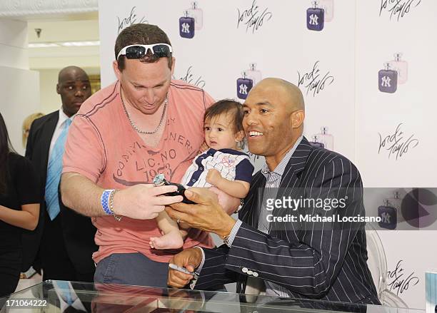 Professional Baseball Player Mariano Rivera poses with fans during The Mariano Rivera Signature Limited Edition EDT At Lord & Taylor on June 21, 2013...