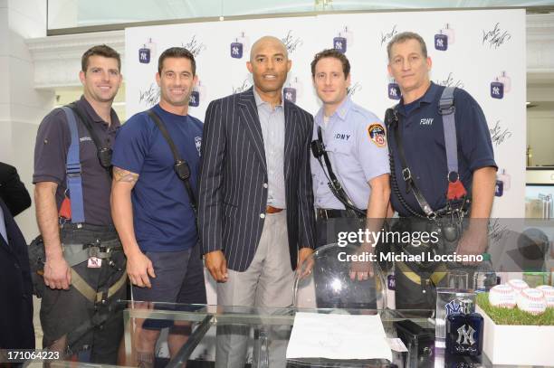 Professional Baseball Player Mariano Rivera poses with members of the FDNY during The Mariano Rivera Signature Limited Edition EDT At Lord & Taylor...