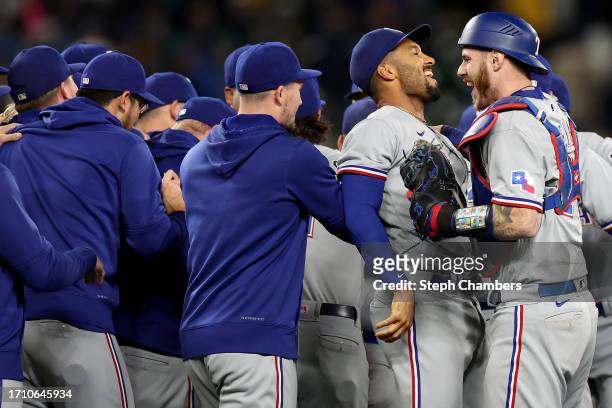 Marcus Semien and Jonah Heim of the Texas Rangers celebrate after beating the Seattle Mariners 6-1 to clinch a 2023 MLB playoff berth at T-Mobile...