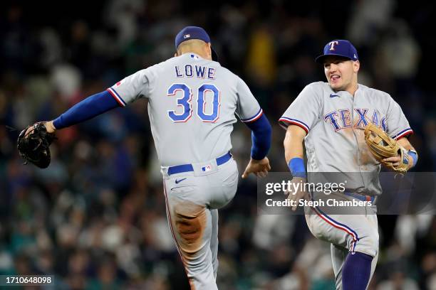 Nathaniel Lowe and Josh Jung of the Texas Rangers celebrate after beating the Seattle Mariners 6-1 to clinch a 2023 MLB playoff berth at T-Mobile...