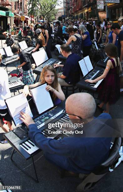 Participants take part in setting the Guiness World Record for the largest keyboard ensemble duing The National Association Of Music Merchants NAMM...