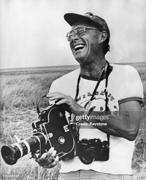 Prince Bernhard of the Netherlands with a movie camera during a visit to Virunga National Park, Zaire , 20th August 1973. The prince is wearing a...