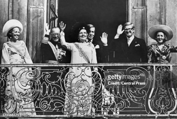 Queen Juliana of the Netherlands and members of the Dutch royal family wave from the balcony of the Lange Voorhout Palace in The Hague after the...