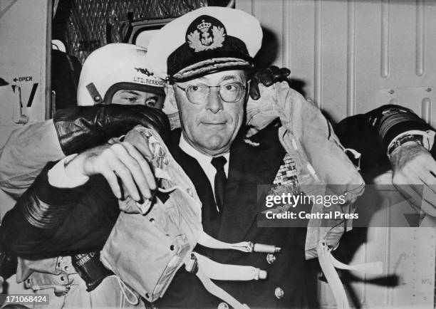 Prince Bernhard of the Netherlands being fitted with a lifejacket on board the Dutch aircraft carrier HNLMS Karel Doorman, during naval manoeuvres in...