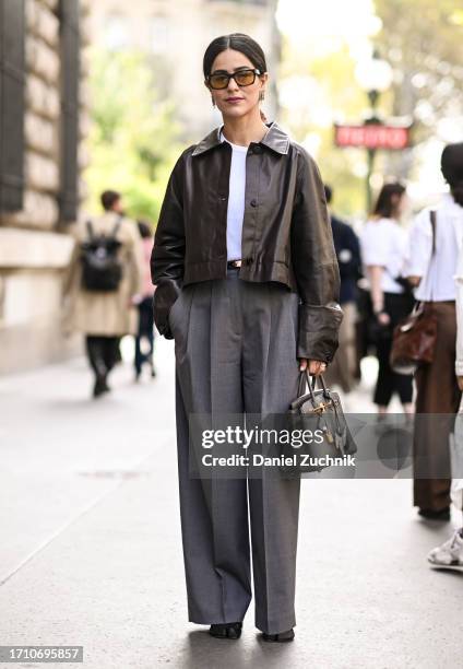 Mer is seen wearing a brown leather jacket, white top, grab pant and Hermes bag outside the Hermes show during the Womenswear Spring/Summer 2024 as...