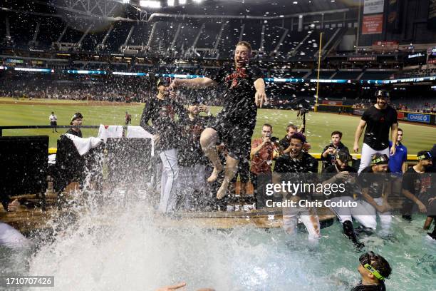 Merrill Kelly of the Arizona Diamondbacks jumps into the Chase Field pool after the Diamondbacks clinched a National League Wild Card playoff spot...