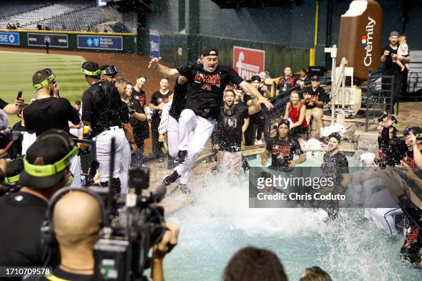 Manager Torey Lovullo of the Arizona Diamondbacks jumps into the Chase Field pool after the Diamondbacks clinched a National League Wild Card playoff...