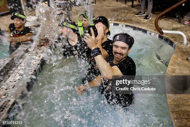 Corbin Carroll of the Arizona Diamondbacks celebrates in the Chase Field pool after the Diamondbacks clinched a National League Wild Card playoff...