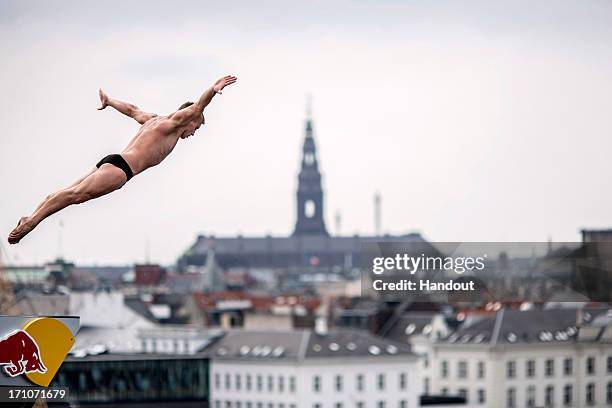 In this handout image provided by Red Bull, Artem Silchenko of Russia dives from the 28-metre platform at the Copenhagen Opera House during the first...