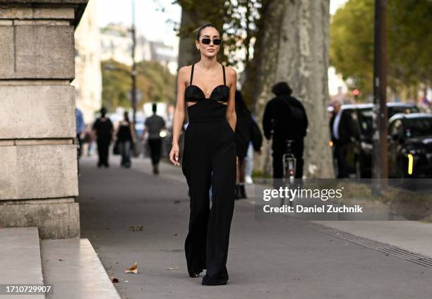 Tamara Kalinic is seen wearing an Elie Saab dress and black and gold sunglasses with a black mini-bag outside the Elie Saab show during the...