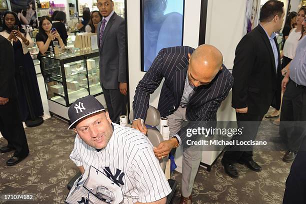 Professional Baseball Player Mariano Rivera signs a fans shirt during The Mariano Rivera Signature Limited Edition EDT At Lord & Taylor on June 21,...