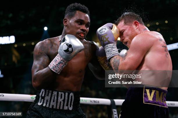 Saul "Canelo" Alvarez of Mexico trades punches with Jermell Charlo during their super middleweight title fight at T-Mobile Arena on September 30,...