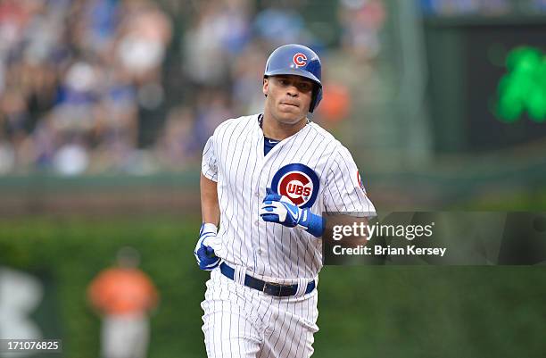 Scott Hairston of the Chicago Cubs rounds the bases after hitting a solo home run during the sixth inning against the Houston Astros at Wrigley Field...