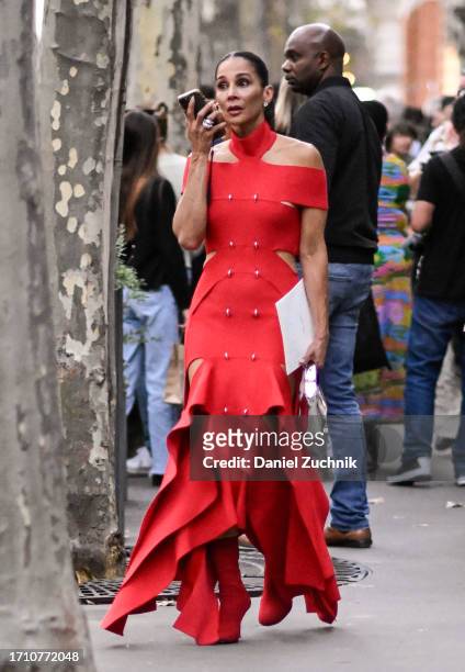 Guest is seen wearing a red Alexander McQueen dress outside the Alexander McQueen show during the Womenswear Spring/Summer 2024 as part of Paris...