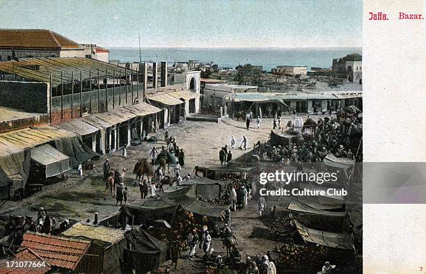 Jaffa market with tent stalls and Arab men shopping. Late 1800s, early 1900s.