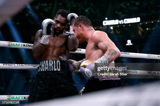 Saul "Canelo" Alvarez of Mexico trades punches with Jermell Charlo during their super middleweight title fight at T-Mobile Arena on September 30,...