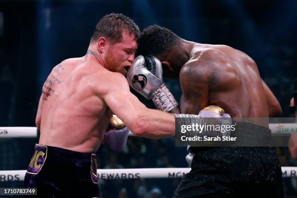Saul "Canelo" Alvarez of Mexico trades punches with Jermell Charlo during their super middleweight title fight at T-Mobile Arena on September 30,...