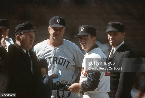 Manager Johnny Pesky of the Boston Red Sox exchange line-up with Manager Bob Scheffing of the Detroit Tigers before the start of a Major League...