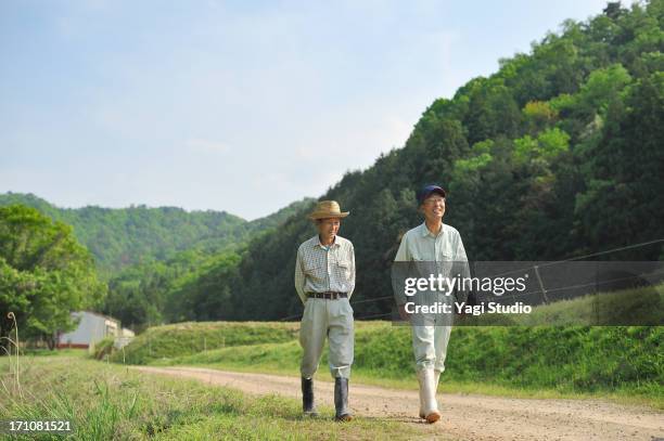 the man of two farmers walking,japan - 農家 ストックフォトと画像